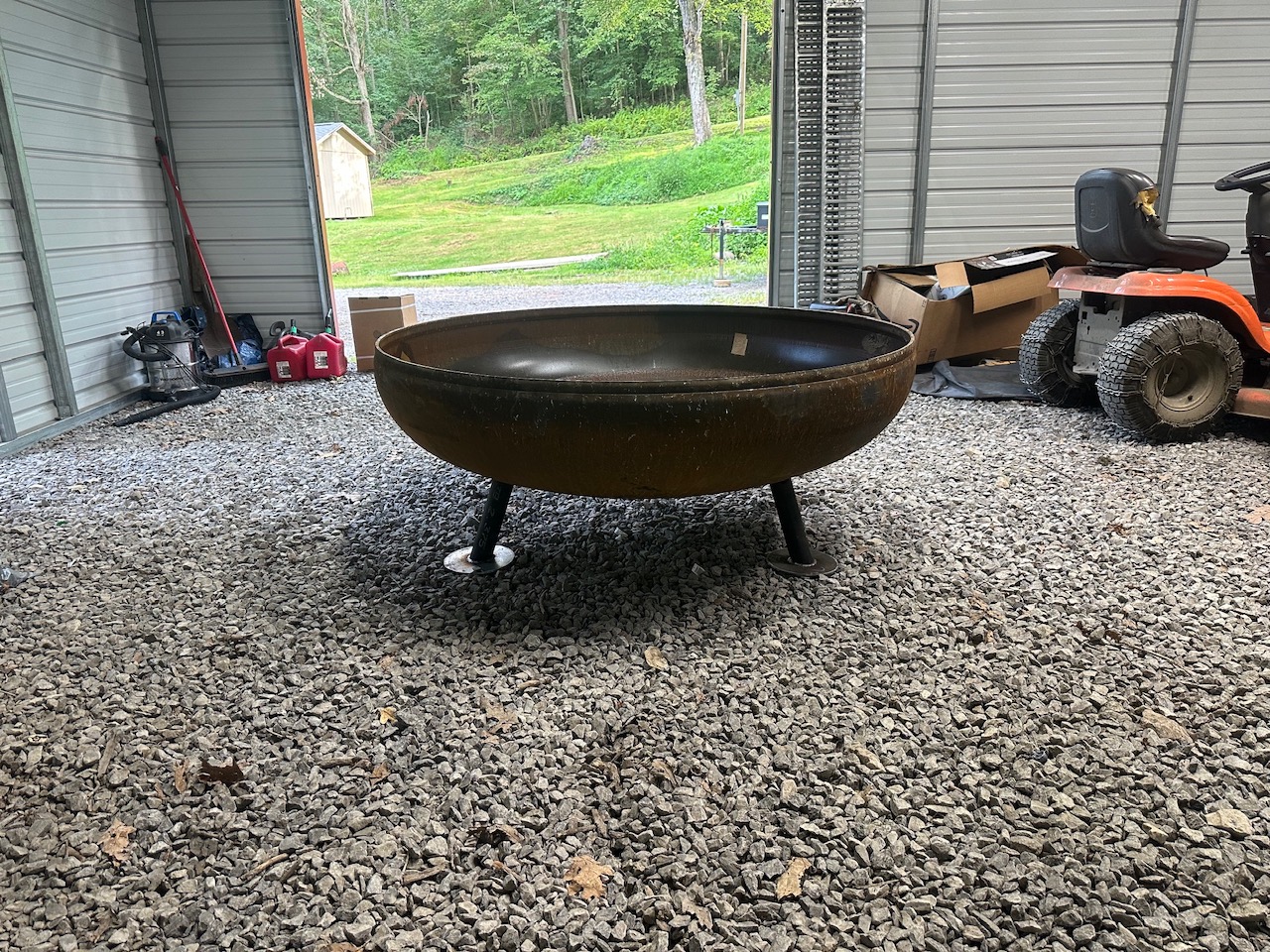 Heavy steel fire pit on gravel outside the shop